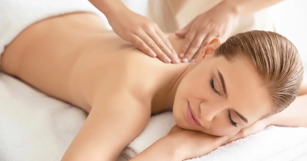Woman relaxing during a lymphatic massage session, lying on a spa bed with eyes closed, promoting relaxation and natural detoxification in ELKO, NEVADA