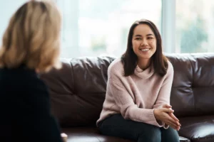 Smiling woman in a relaxed medical aesthetic consultation with a provider in Elko.