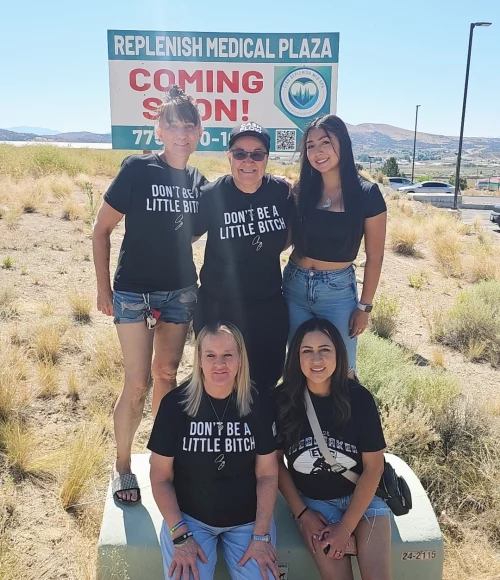 Elko Replenish Med Spa team by “Coming Soon” sign at future location.