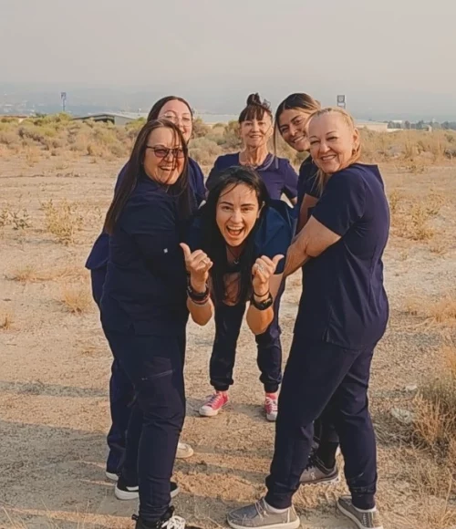 Team members of Elko Replenish Med Spa smiling outdoors.